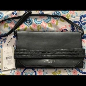 NWT Black leather purse. Opens wide.